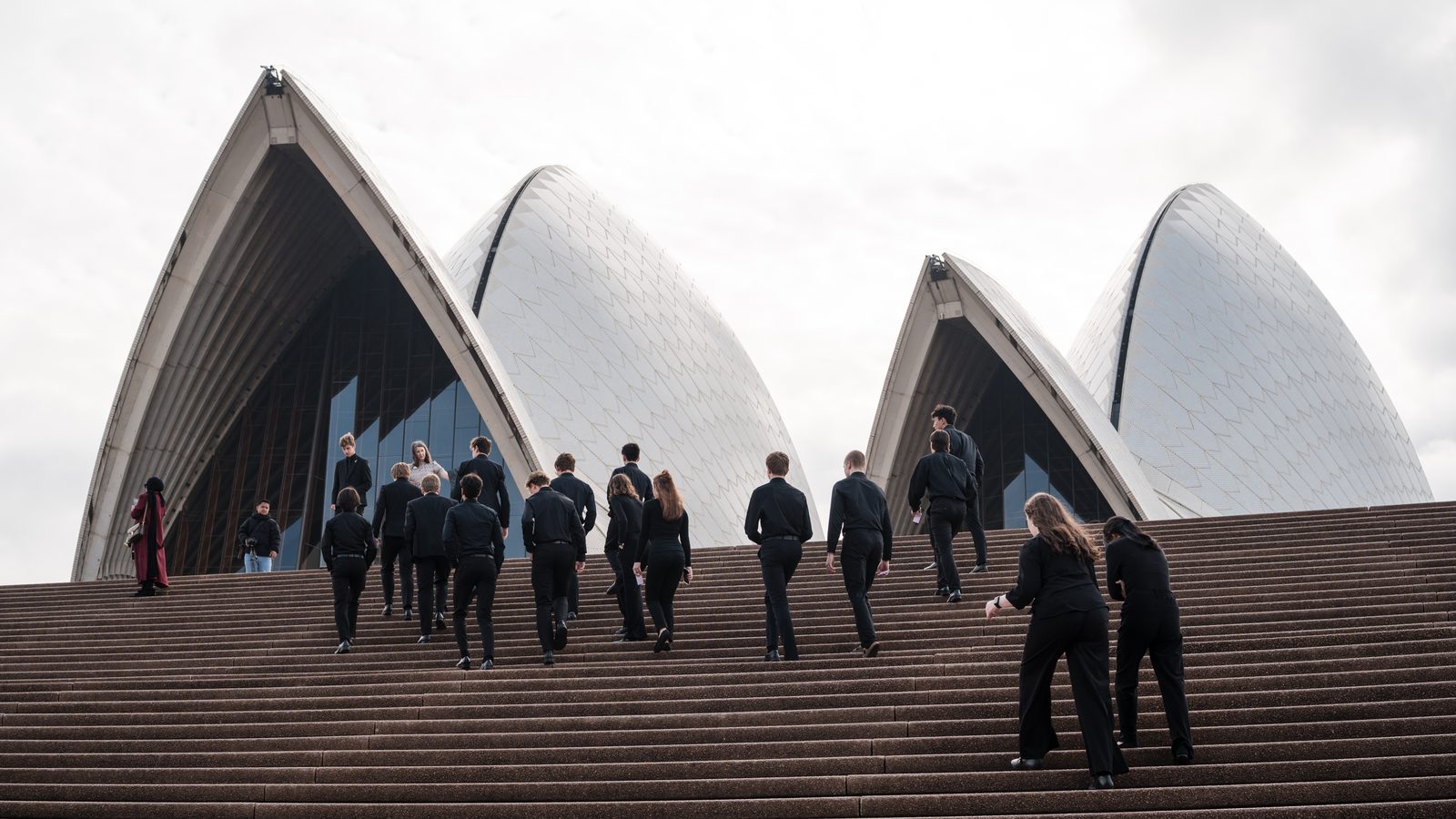 Performers climbing the Sydney Opera House steps
