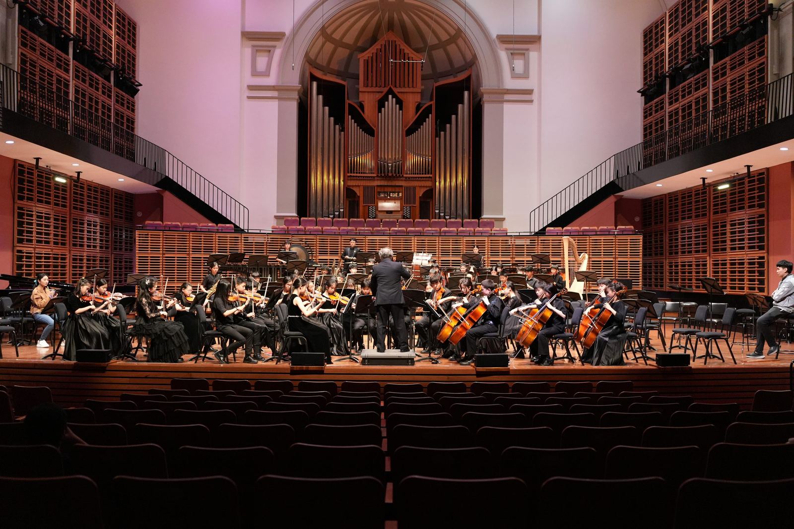Orchestra performing beneath the pipe organ
