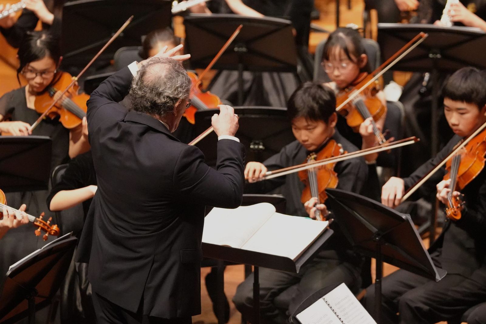 Young violinists watching the conductor