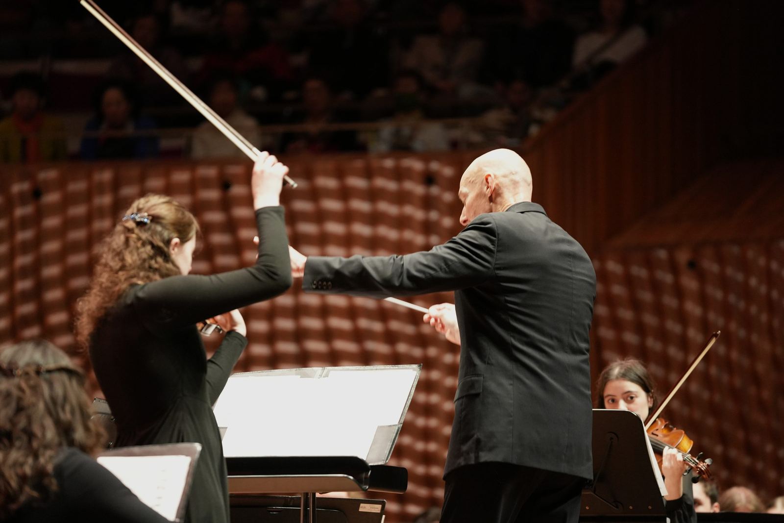 Soloist and conductor mid performance
