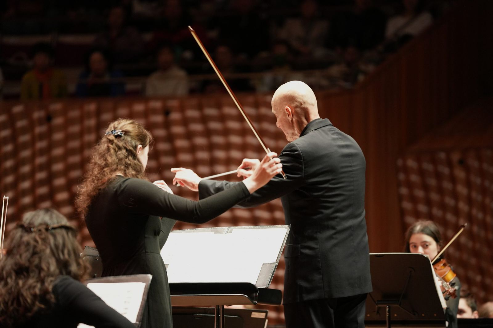 Soloist and conductor, bows raised together